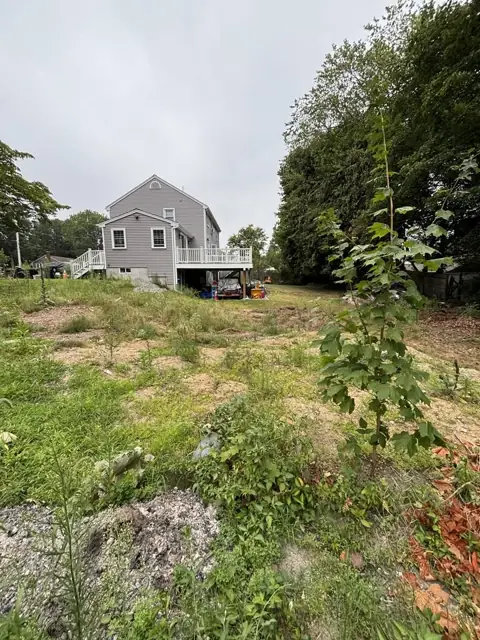 New Lawn & Retaining Wall With Built-In Staircase in Norfolk, MA by LD Landscape & Construction — photo 1
